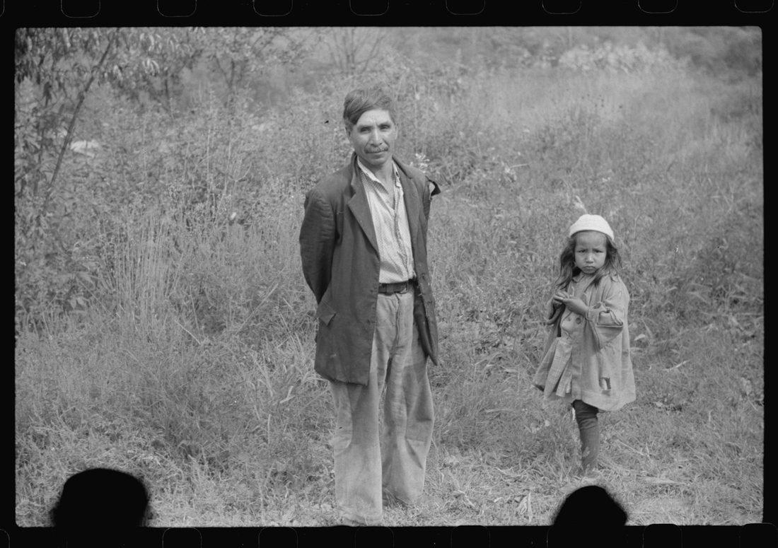 Mexican miner and child, Bertha Hill, West Virginia. Many Mexicans and Negroes were brought into Scotts Run around 1926 to break the strike. Now about one fourth of all mines emplo
